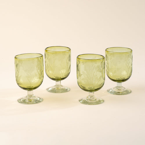 Four olive short wine glasses made of recycled glass with etched thistle designs on it